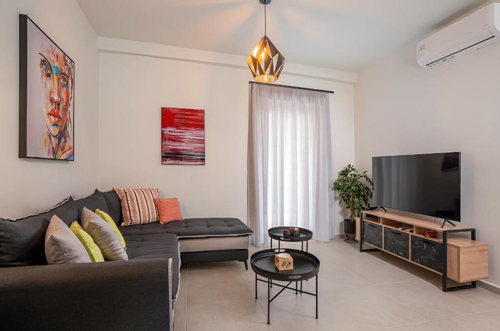 Televízia a/alebo spoločenská miestnosť v ubytovaní Harbour Hill Suites