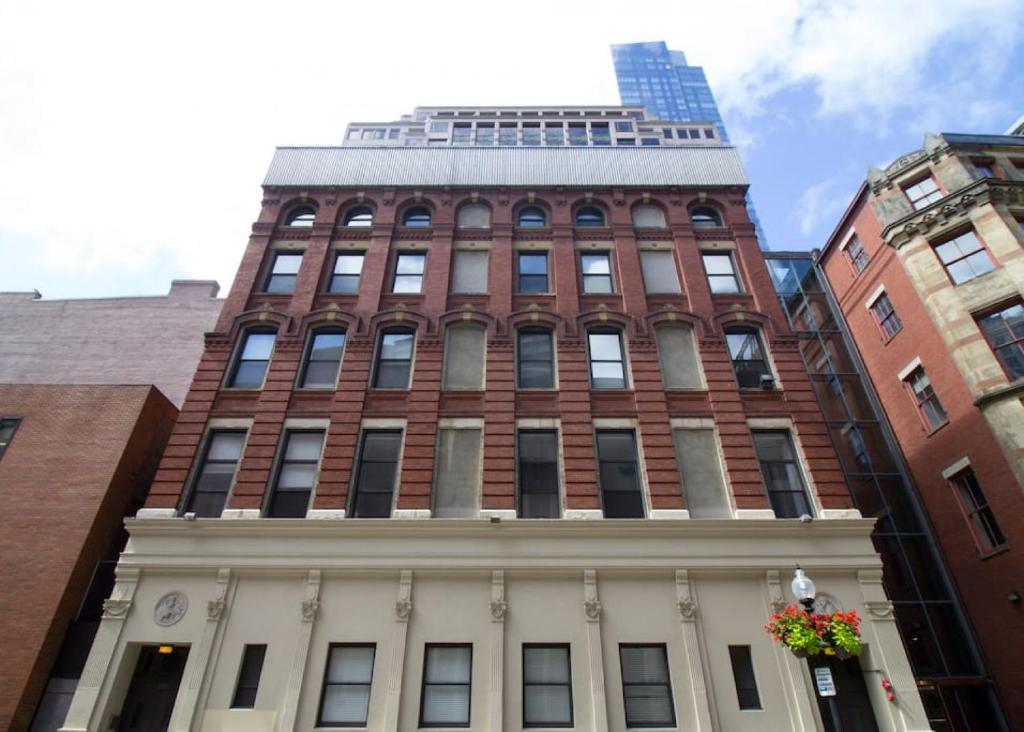 a tall red brick building with a tower at Luxury at 2br 2ba 200mbps Internet in Boston