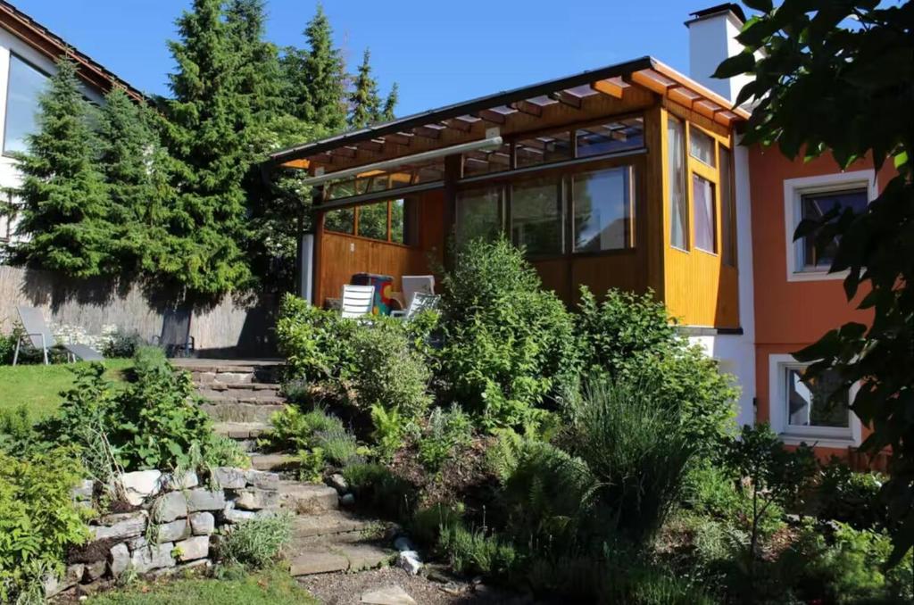 a house with a garden in front of it at Haus Freigeist in Murnau am Staffelsee