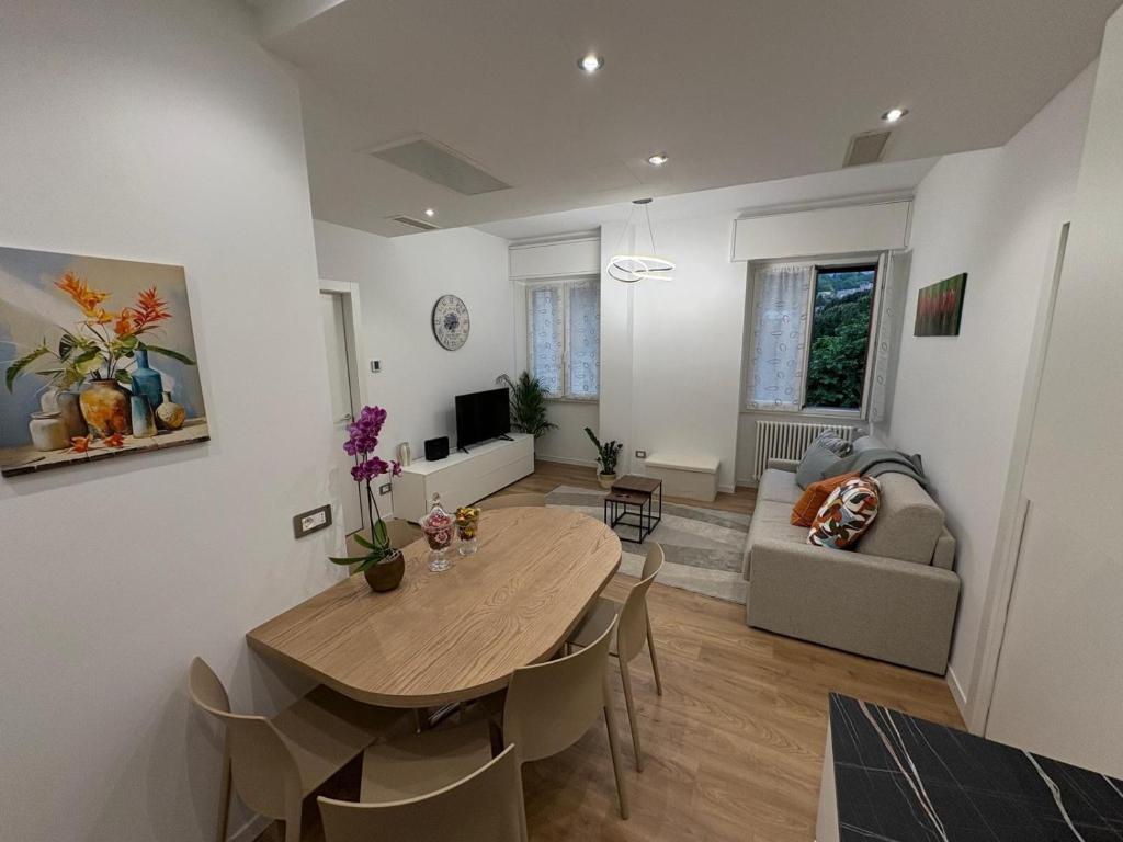 a living room with a table and a couch at Focolare Manzoni in Lecco