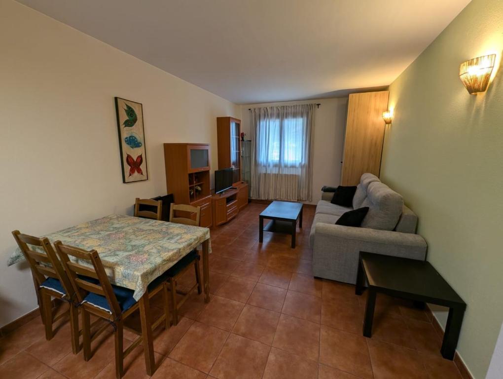 a living room with a couch and a table at Casa espelunciecha in Biescas