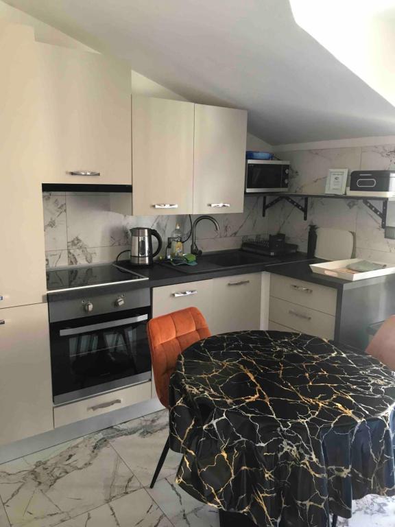 a kitchen with a table and a stove top oven at Villa Marica in Trogir