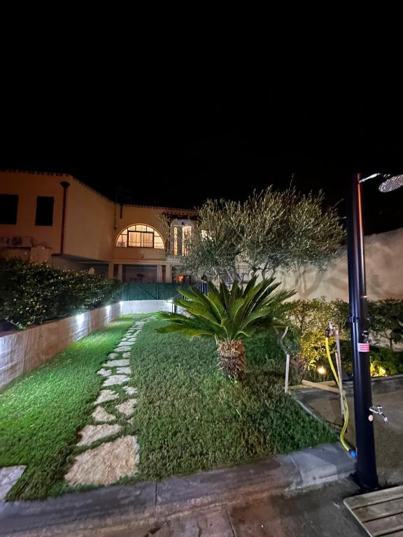 a garden in front of a house at night at Casa Clelia in Pula