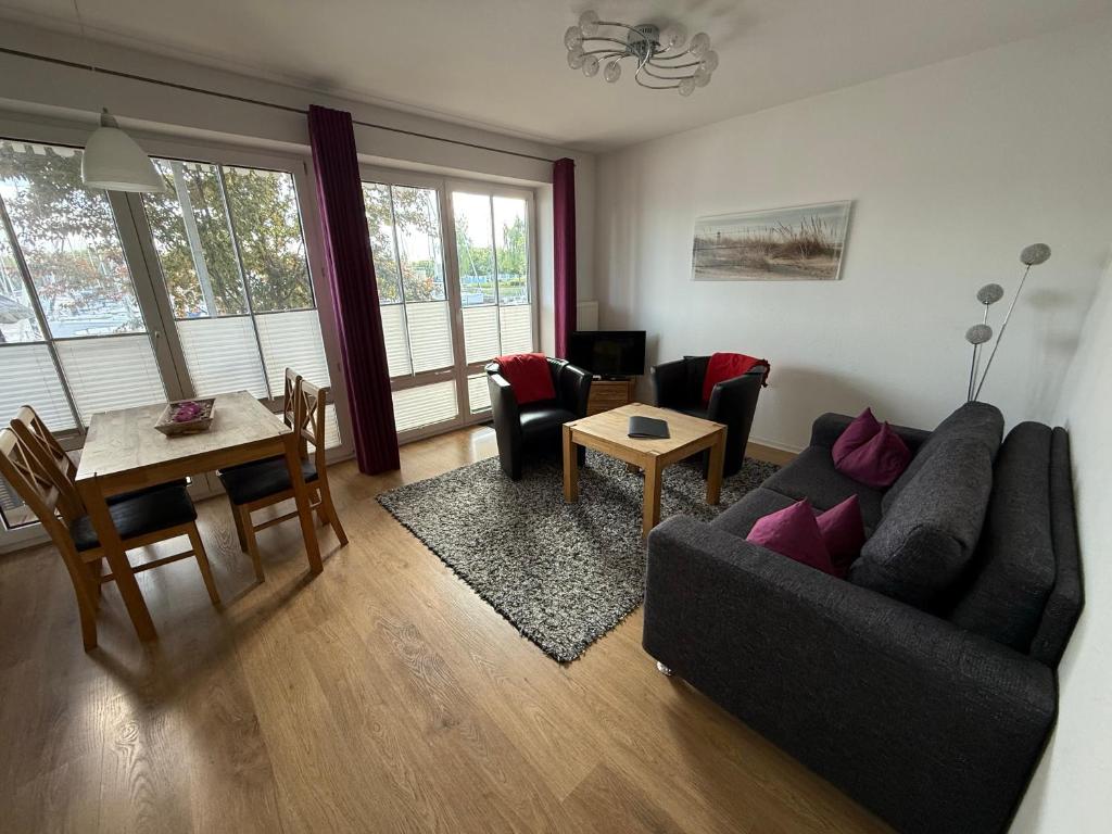 una sala de estar con un sofá y una mesa en Ferienwohnung Holzteichstraße 11, en Greifswald