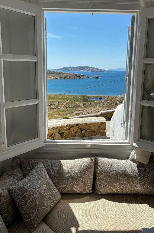 a window in a room with a view of the ocean at Blue and white Mykonos in Mikonos