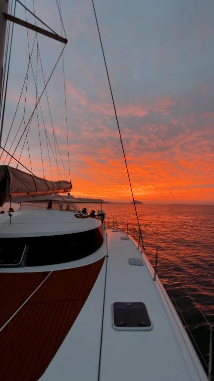 a boat in the ocean with a sunset in the background at Alion Yacht in Altea
