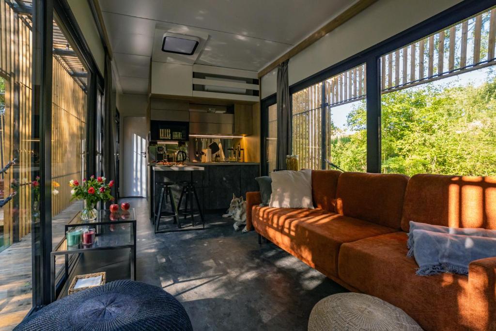 a living room with a couch and some windows at Water Hideout - Floating Luxury in Pure Wilderness in Wysoka