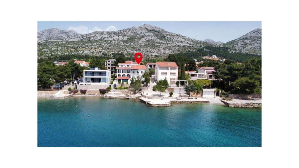 a group of buildings on the shore of a body of water at Sea Breeze Apartments in Starigrad-Paklenica
