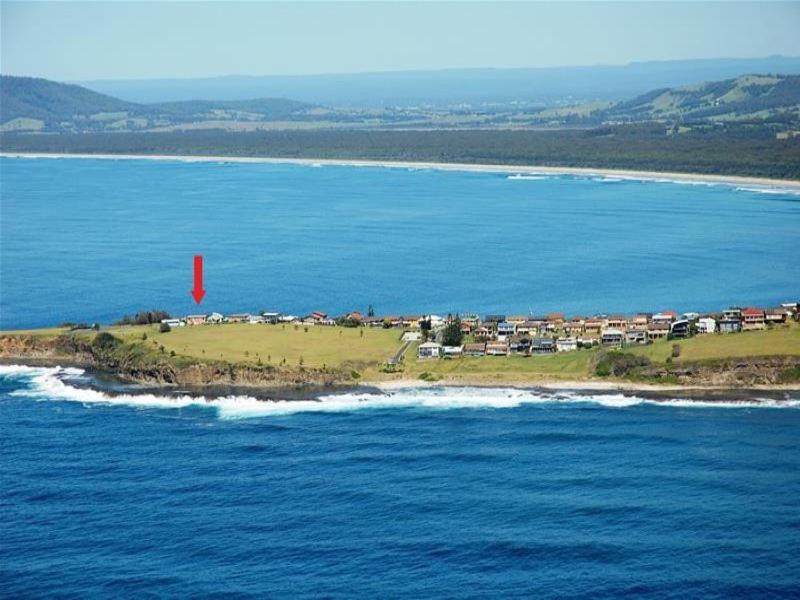 a small island in the ocean with a red marker at The Green Dragon in Gerroa