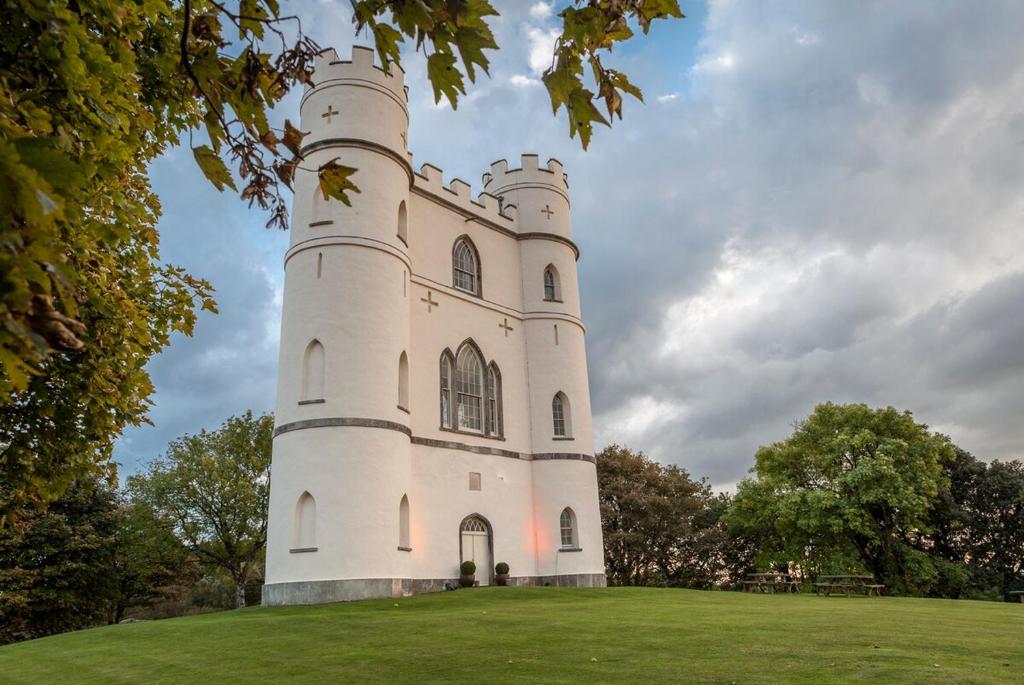 a castle on top of a grass field at Haldon Belvedere Lawrence Castle in Halton