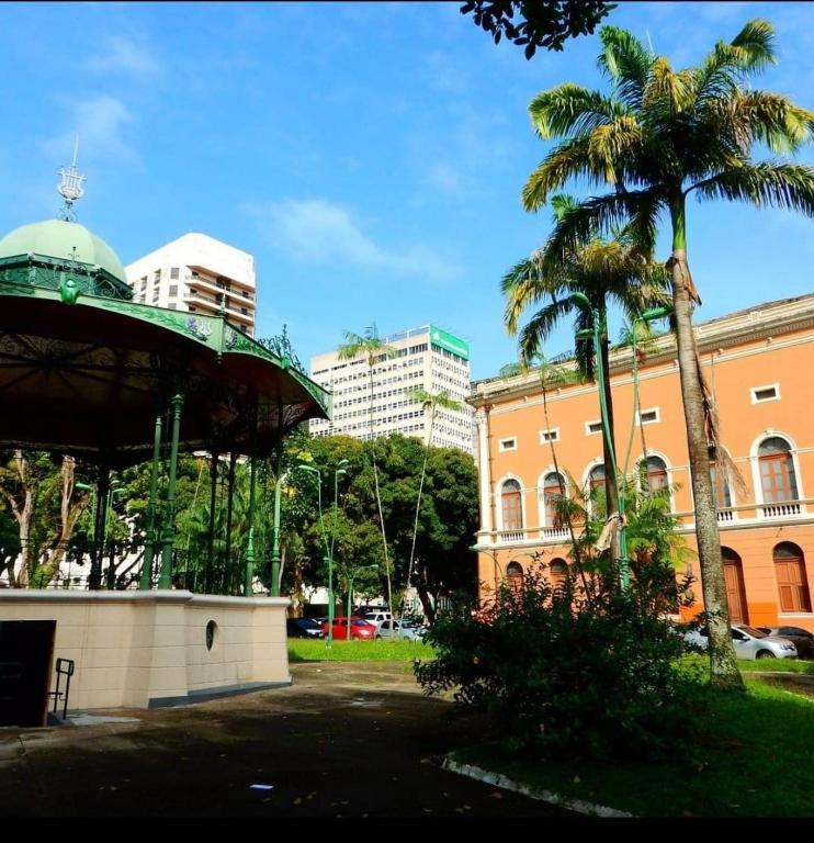 a palm tree next to a building with a dome at casa da Maria aconchegante in Belém