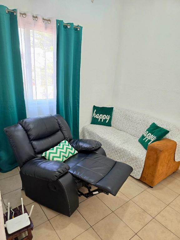 a living room with a couch and a chair at Tu espacio ideal in San Miguel