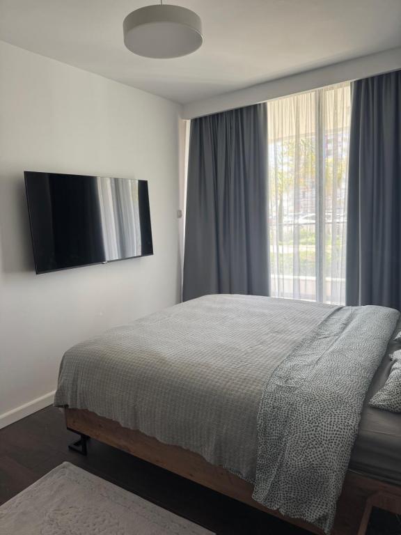 a bedroom with a bed and a large window at Grand Sapphire Casino 1 bdr 002 in Iskele