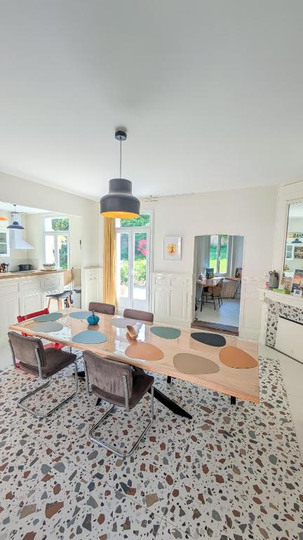 une cuisine avec une table et des chaises dans une pièce dans l'établissement Villa Amica, Terrasse et jardin, à 50m de la plage, à Villers-sur-Mer