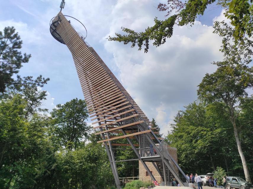 a tall wooden structure in a park at Wildkamp Resort Zelten in der freien Natur ( Wiese Wald ) in Rimbach