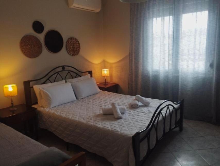 a bedroom with a bed with two towels on it at Cleopatra's Cozy Cottage in Keramoti
