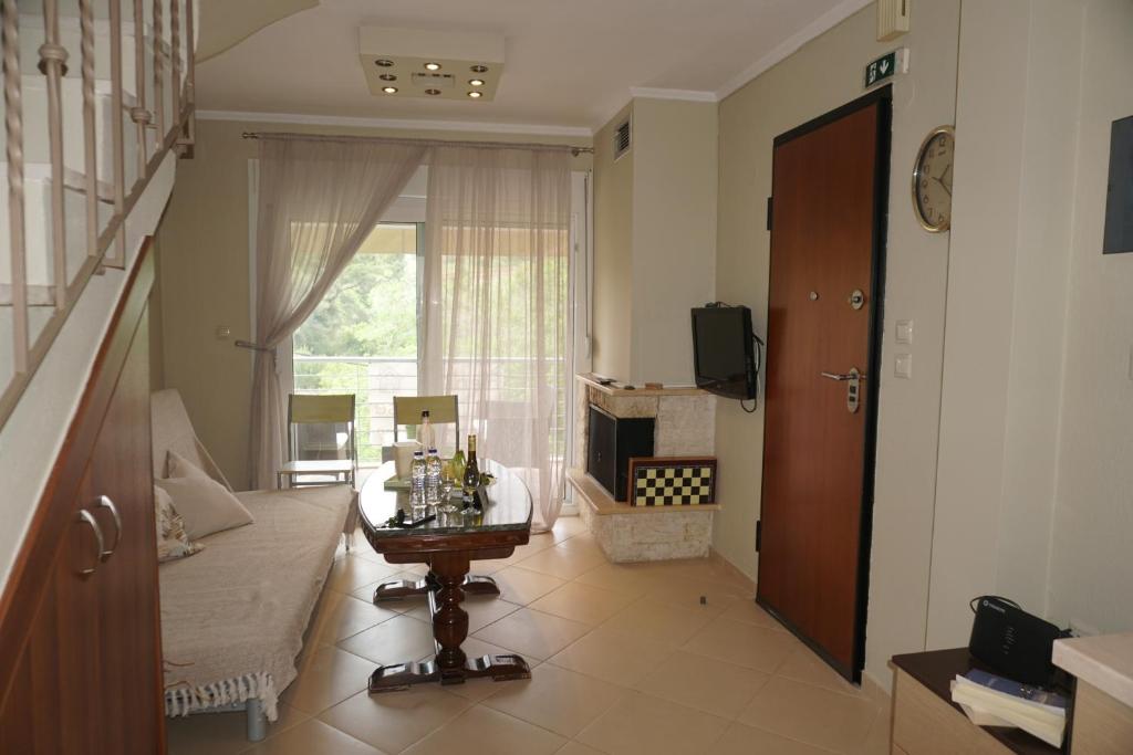 a living room with a couch and a window at ELENI'S HOUSE in Nea Fokea