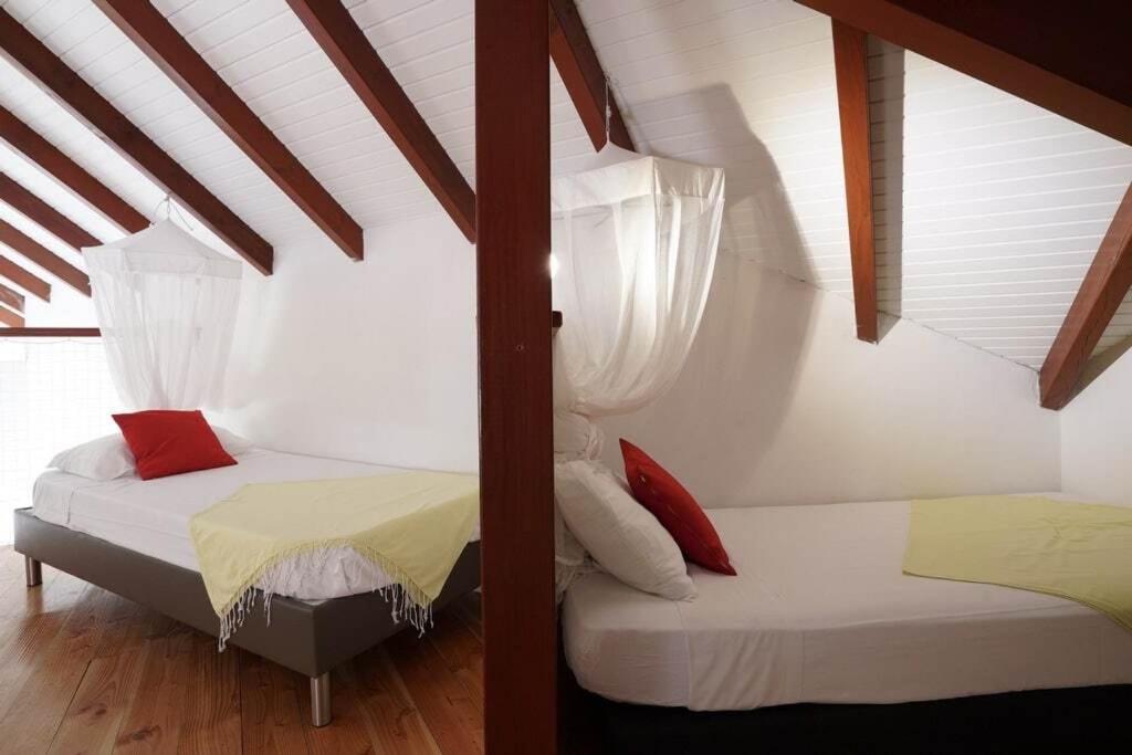Postel nebo postele na pokoji v ubytování Le Jardin des Ilets