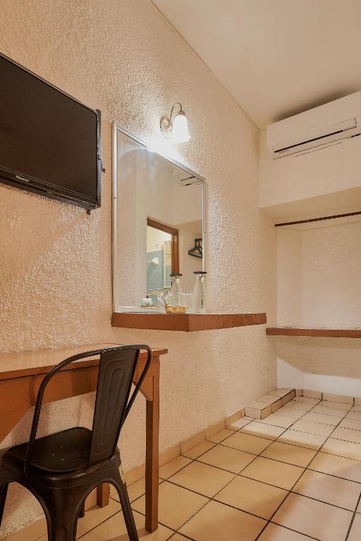 TV a/nebo společenská místnost v ubytování Hotel Cervantino