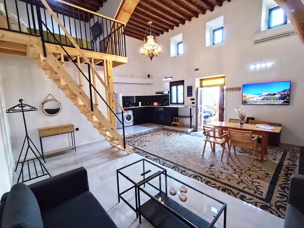 ein Wohnzimmer mit Treppe und ein Esszimmer in der Unterkunft Lindos Central in Lindos
