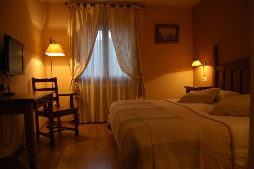 Postel nebo postele na pokoji v ubytování Hotel Areulo