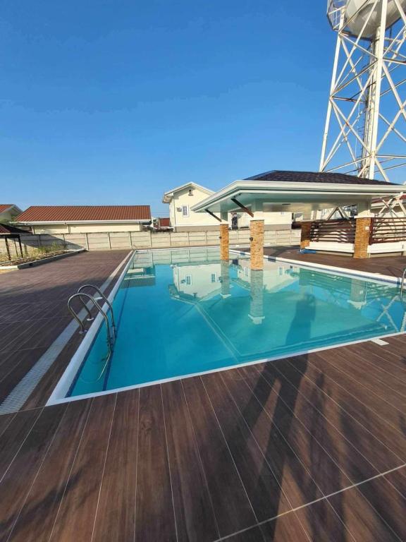 a swimming pool on top of a deck with a water tower at Panglao Bohol Transient house in Dauis