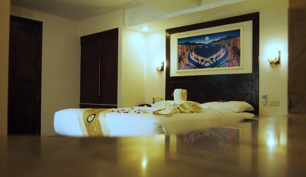 Postel nebo postele na pokoji v ubytování Paradise Inn