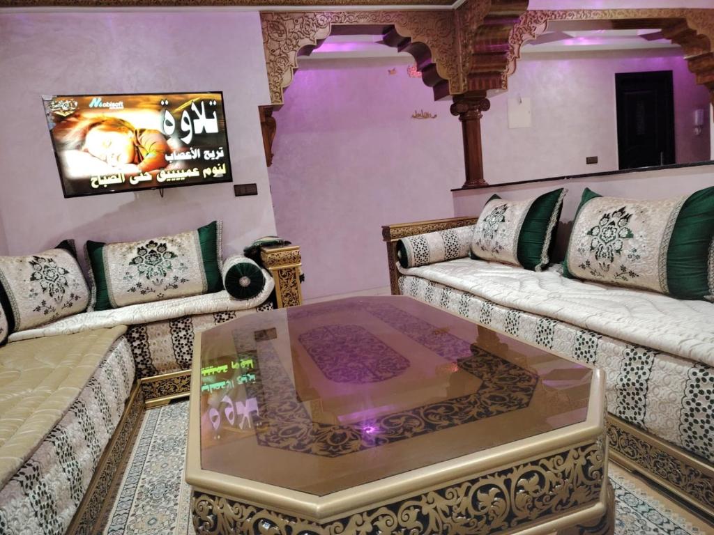 a living room with two couches and a tv at شقة قرب المطارApartement 5min a l'aéroport , only family in Tangier