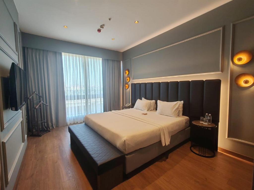 a hotel room with a bed and a television at ISG Sabiha Gökçen Airport Hotel in Istanbul