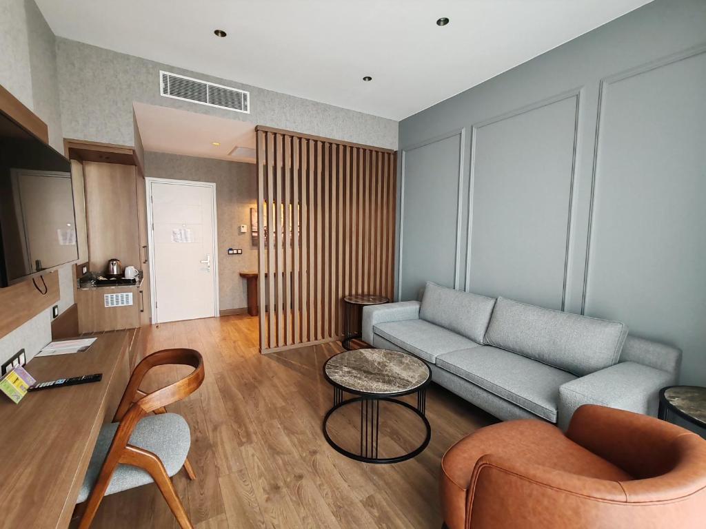 a living room with a couch and a table at ISG Sabiha Gökçen Airport Hotel in Istanbul