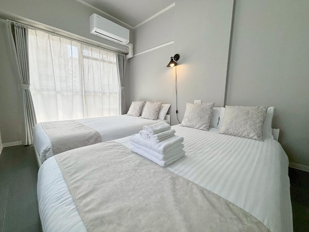 Postel nebo postele na pokoji v ubytování Neighbor's Hotel 西十日市
