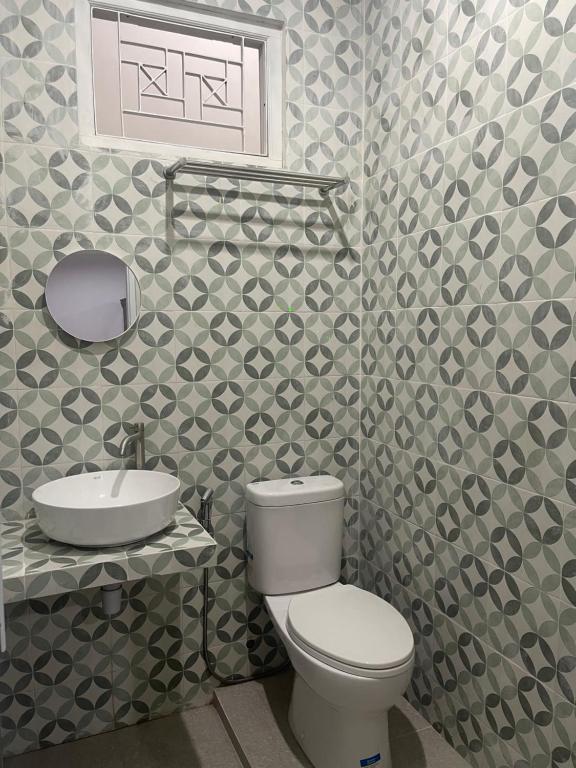 a bathroom with a toilet and a sink at Villa Sukun in Yogyakarta