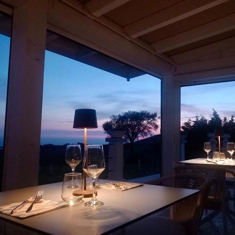 a table with wine glasses sitting on top of it at Casamediterranea in Sperlonga