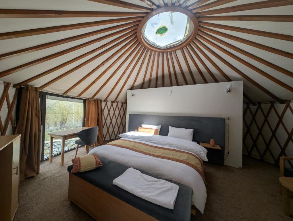 a bedroom with a large bed in a yurt at Apex Hotels and Resorts Phander Ghizer in Gologh Muli