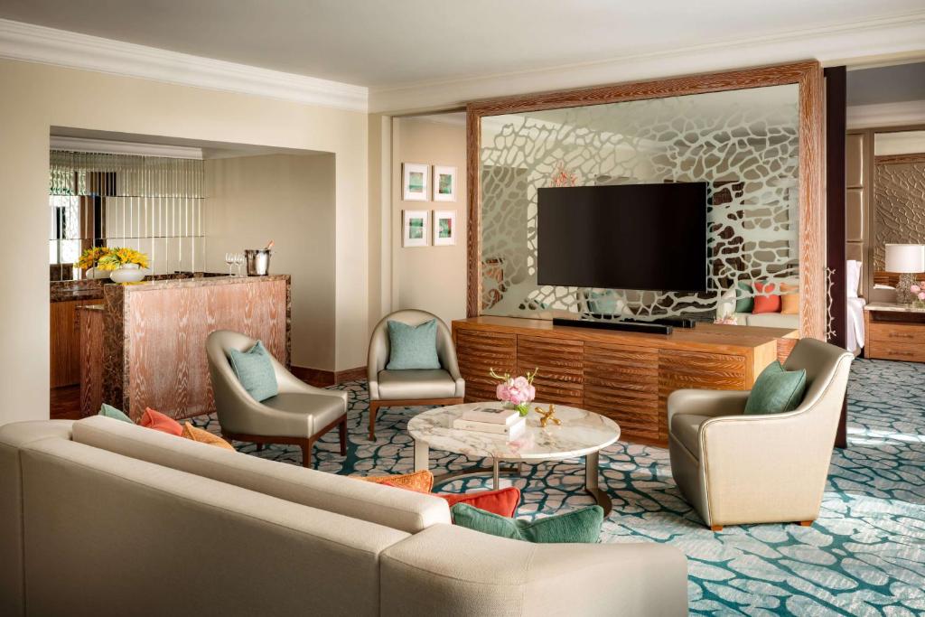 a living room with a couch and a tv at Atlantis, The Palm in Dubai