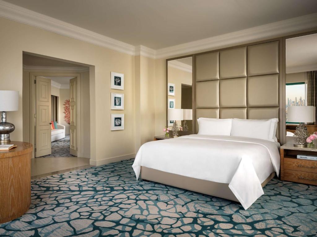 a bedroom with a large white bed and a corridor at Atlantis, The Palm in Dubai