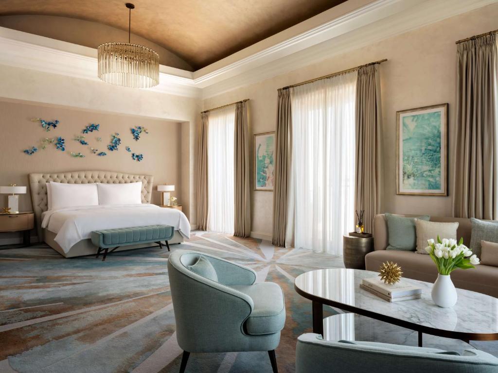 a hotel room with a bed and a table and chairs at Atlantis, The Palm in Dubai