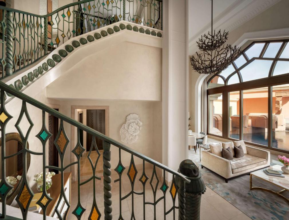 a staircase with stained glass windows and a living room at Atlantis, The Palm in Dubai