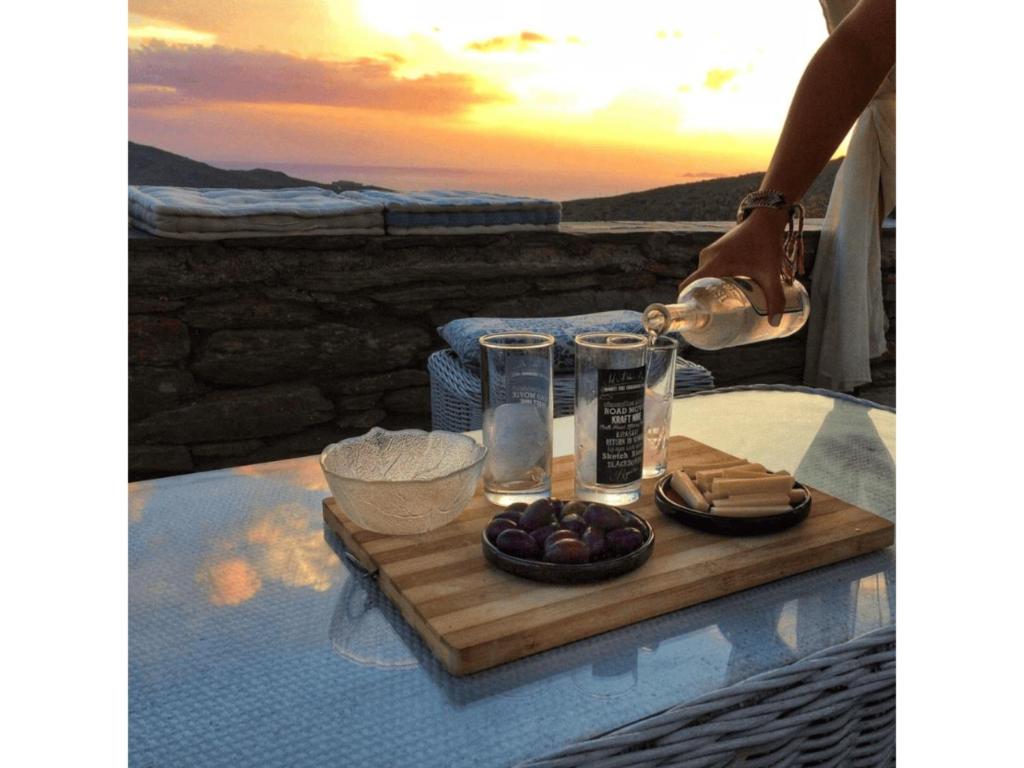 a tray of food on a table with a plate of food at Kotseli - Sea View, Pool, Sunsets in Andros