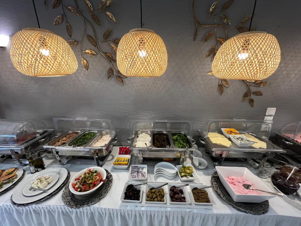 a buffet table with many different food items on it at Thalia deco City & Beach Hotel in Hersonissos