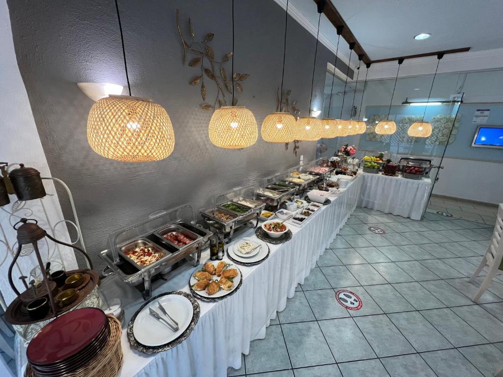 a buffet line with plates of food and lights at Thalia deco City & Beach Hotel in Hersonissos