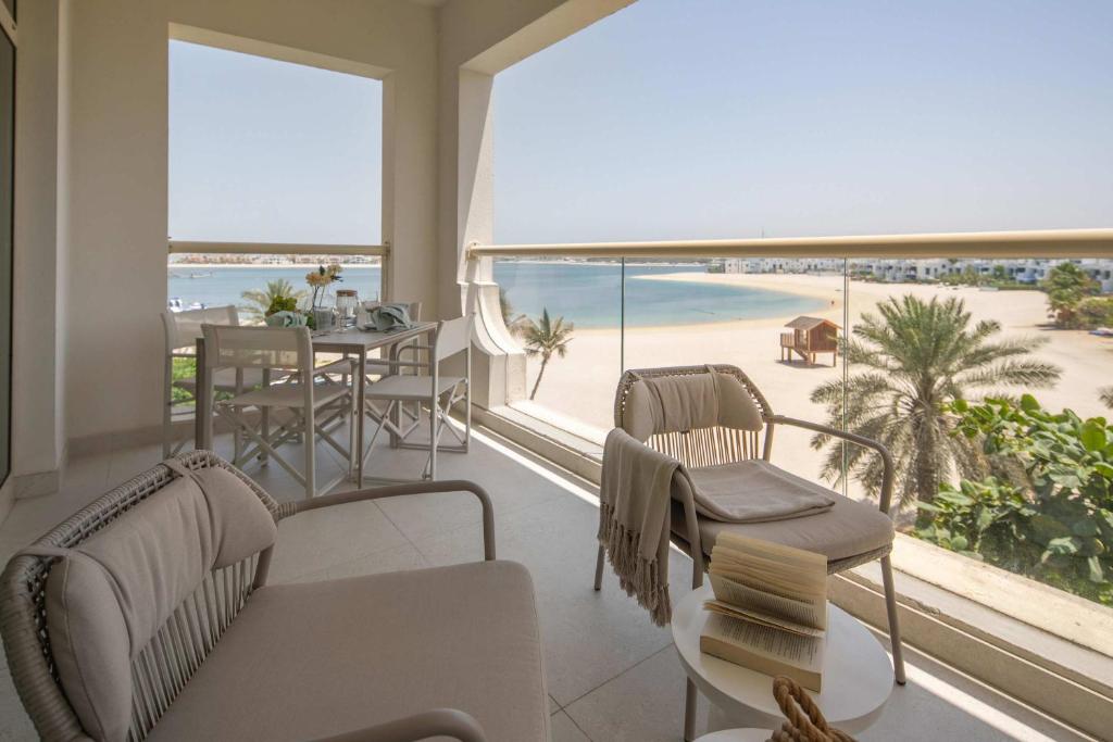 a living room with a view of the beach at Frank Porter - Al Haseer in Dubai