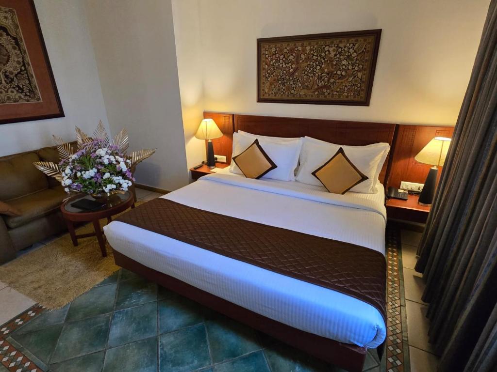 Postel nebo postele na pokoji v ubytování Harrisons Hotel