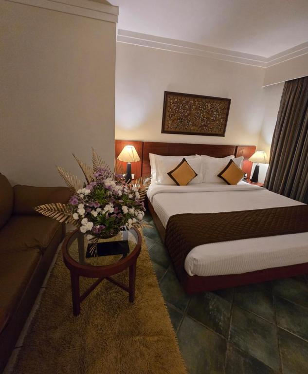 Postel nebo postele na pokoji v ubytování Harrisons Hotel