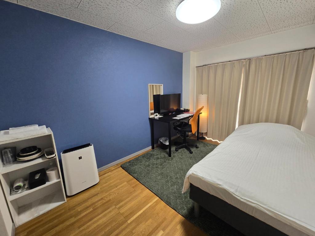 Ένα ή περισσότερα κρεβάτια σε δωμάτιο στο エバグリーンヴィラ太秦206もみじ