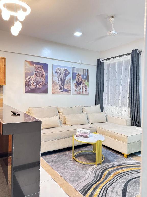 a living room with a couch and a table at Mima homes in Gatunga
