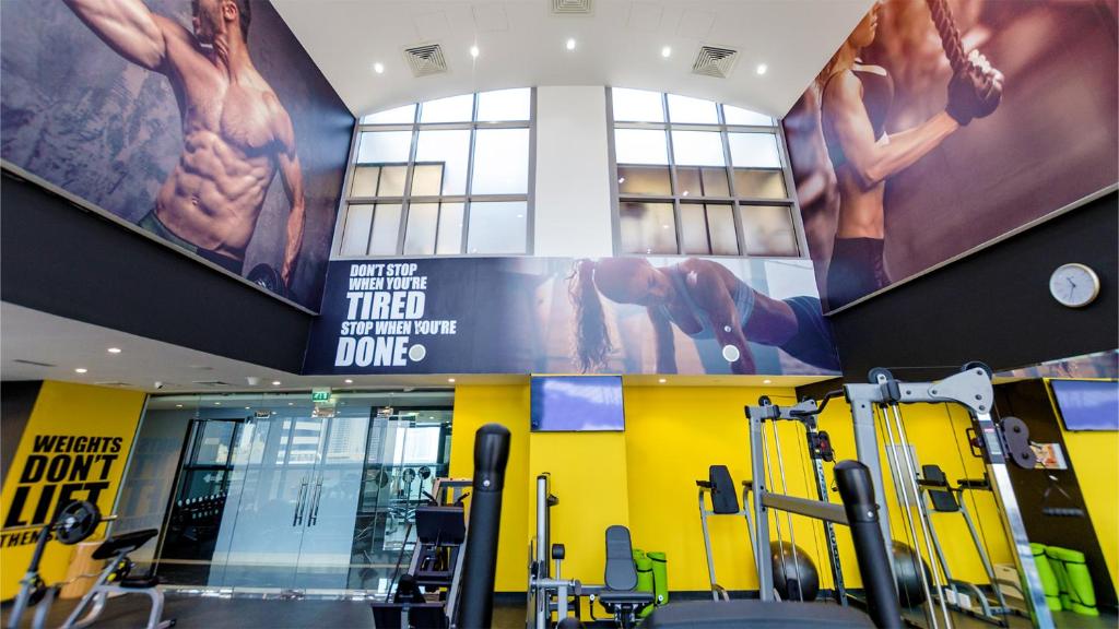 a gym with a large poster on the wall at Signature 1 Hotel Tecom in Dubai