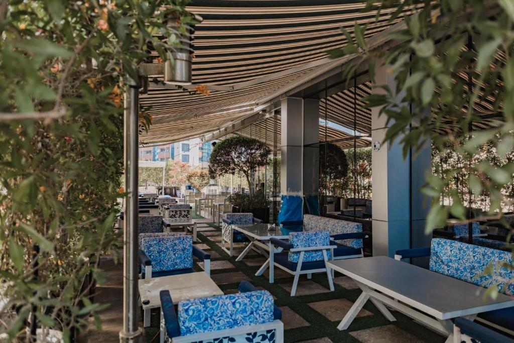 a row of tables and chairs on a patio at Signature 1 Hotel Tecom in Dubai