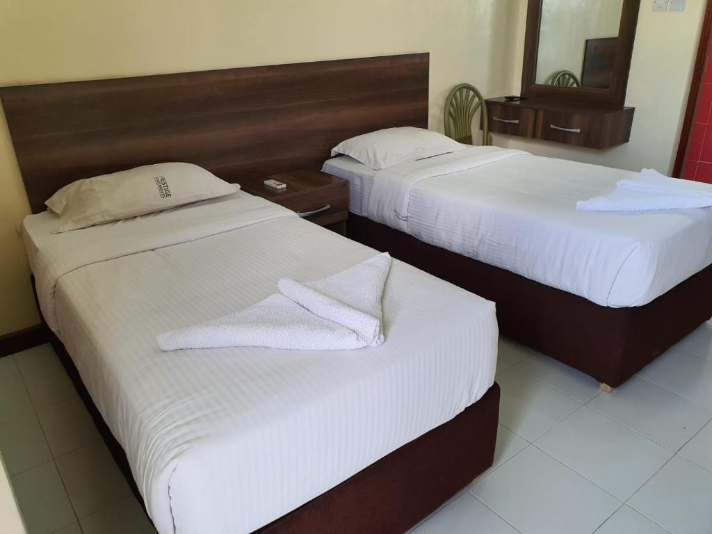 Postel nebo postele na pokoji v ubytování Prestige Leisure Hotel