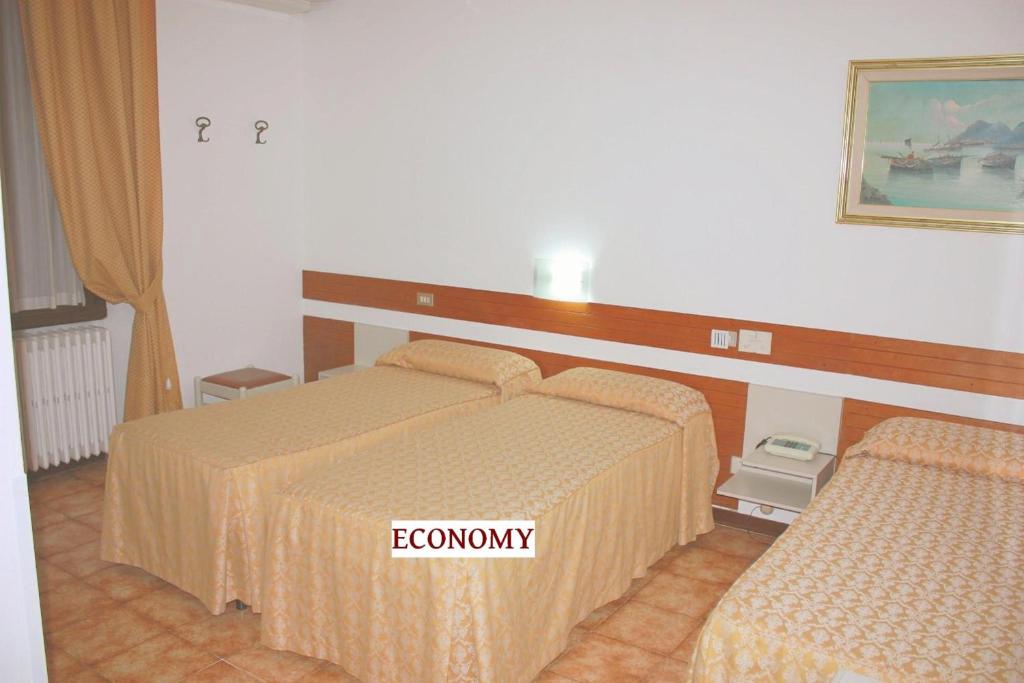 Postel nebo postele na pokoji v ubytování Piccolo Hotel